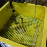 We use a cleaning tank with solvent to degrease the parts.